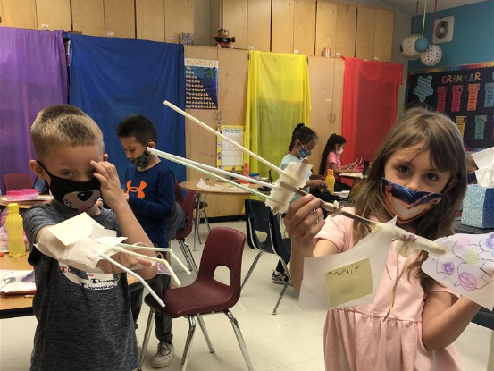 students with back scratchers they created as inventors